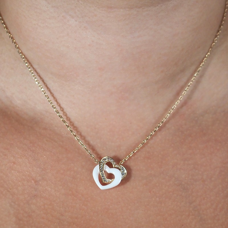 Collier fantaisie doubles coeurs entremêlés femme carador en plaqué or avec oxydes de zirconium et céramique blanche