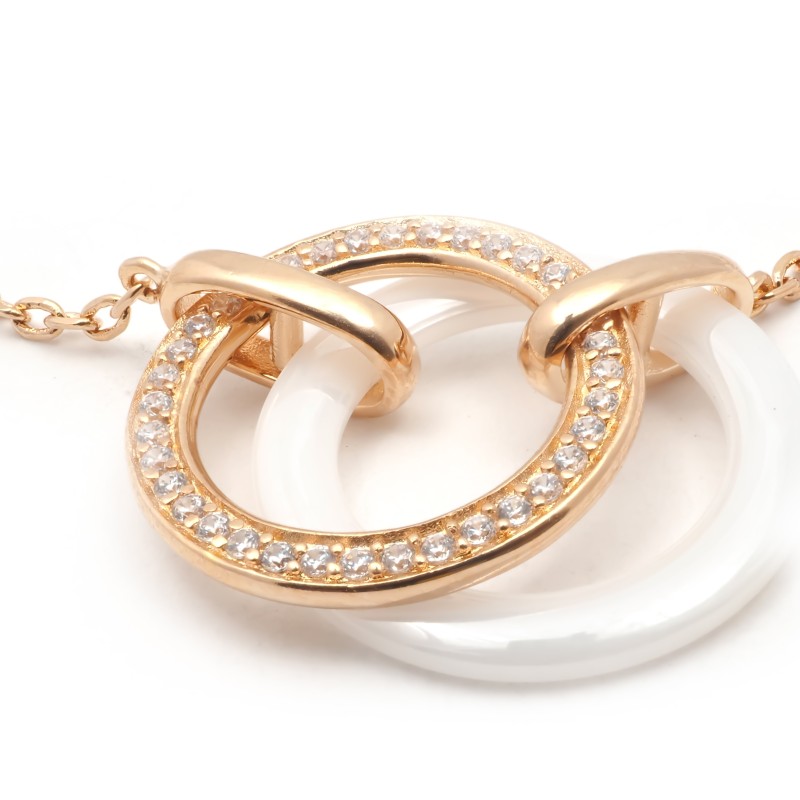 Bracelet fantaisie deux anneaux entrelacés femme carador en plaqué or avec oxydes de zirconium et céramique blanche