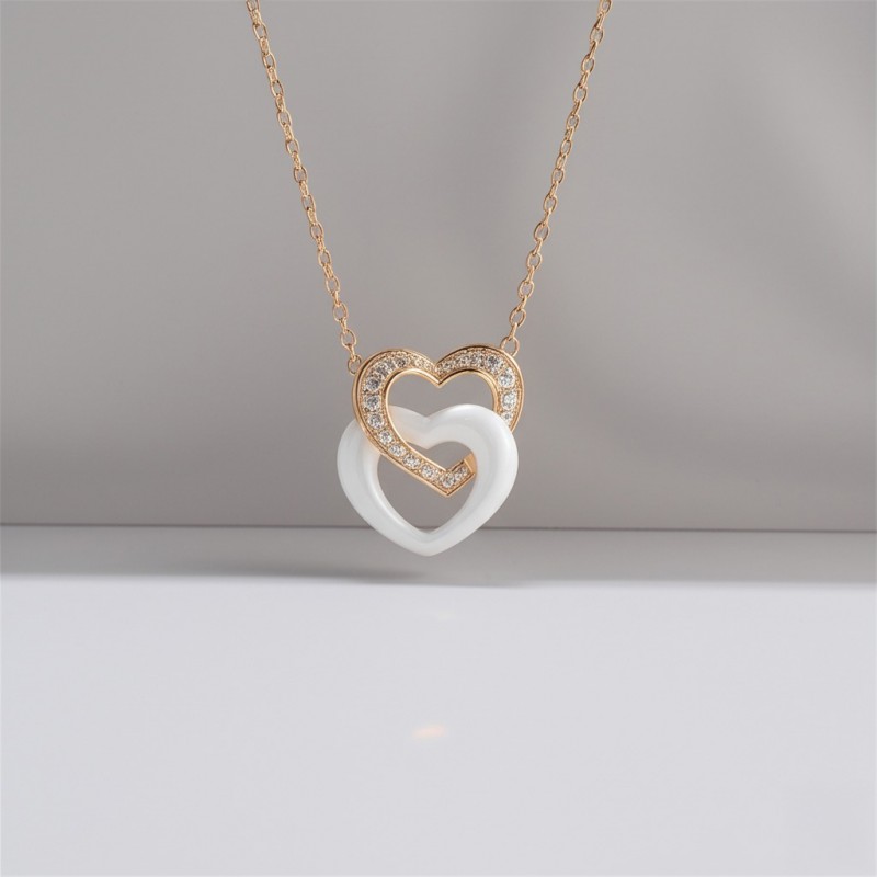 Collier fantaisie doubles coeurs entremêlés femme carador en plaqué or avec oxydes de zirconium et céramique blanche